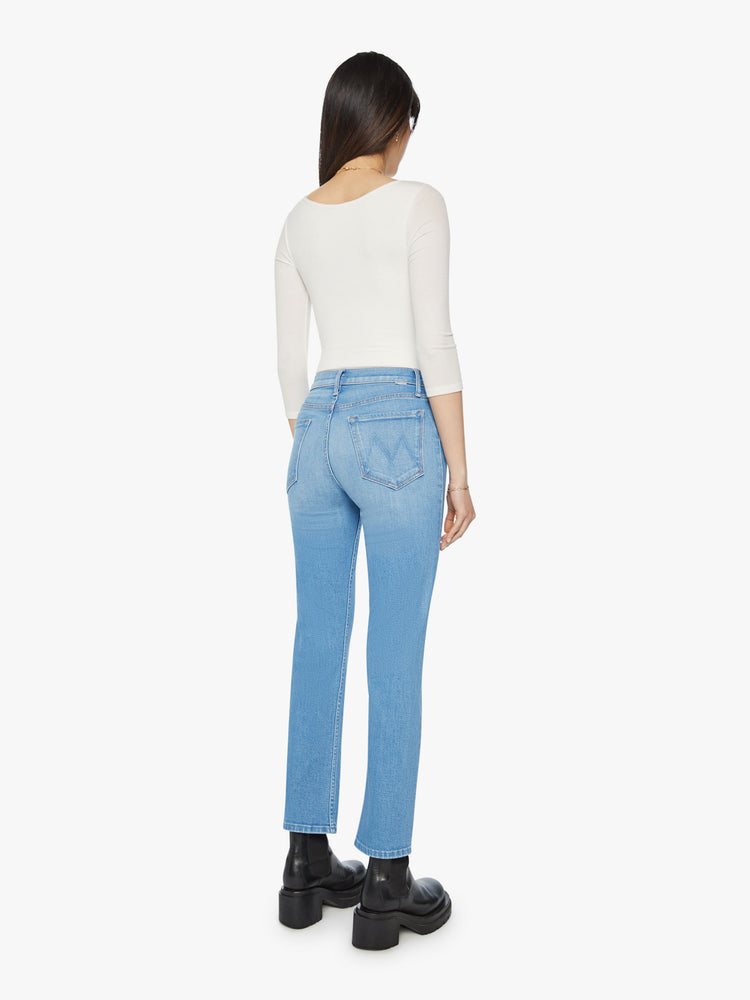 Back view of a woman high rise jean with a straight leg, button fly and a 28.25-inch inseam with a clean hem in light blue wash.