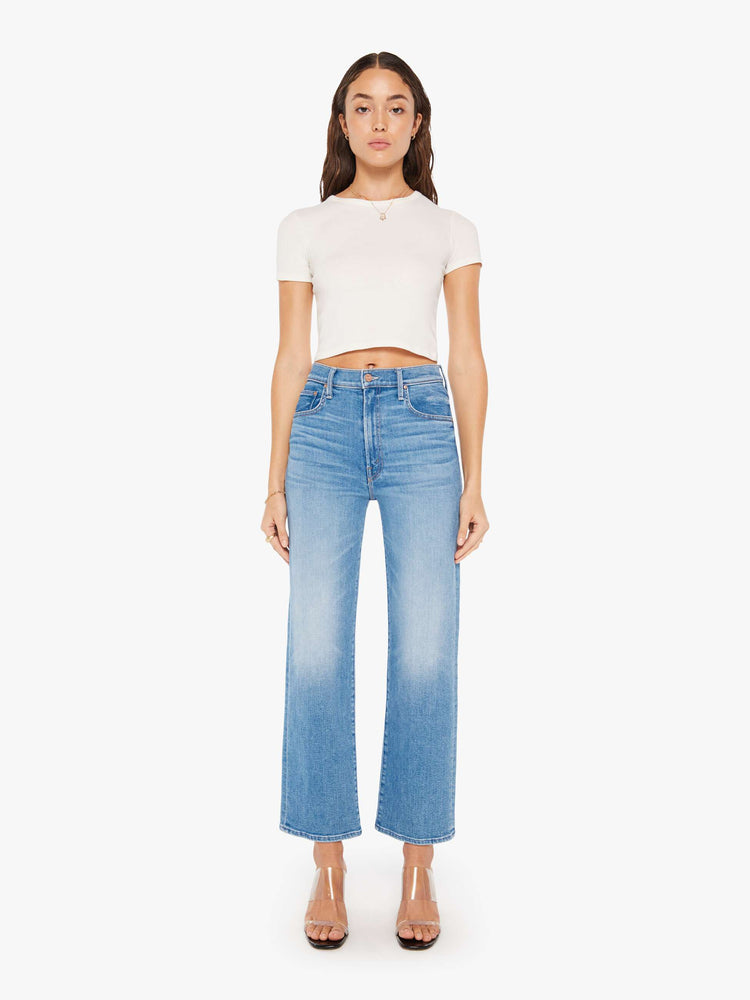 Front view of a woman high-waisted jean with a wide straight leg, zip fly and clean 28.25-inch inseam in a mid blue wash.