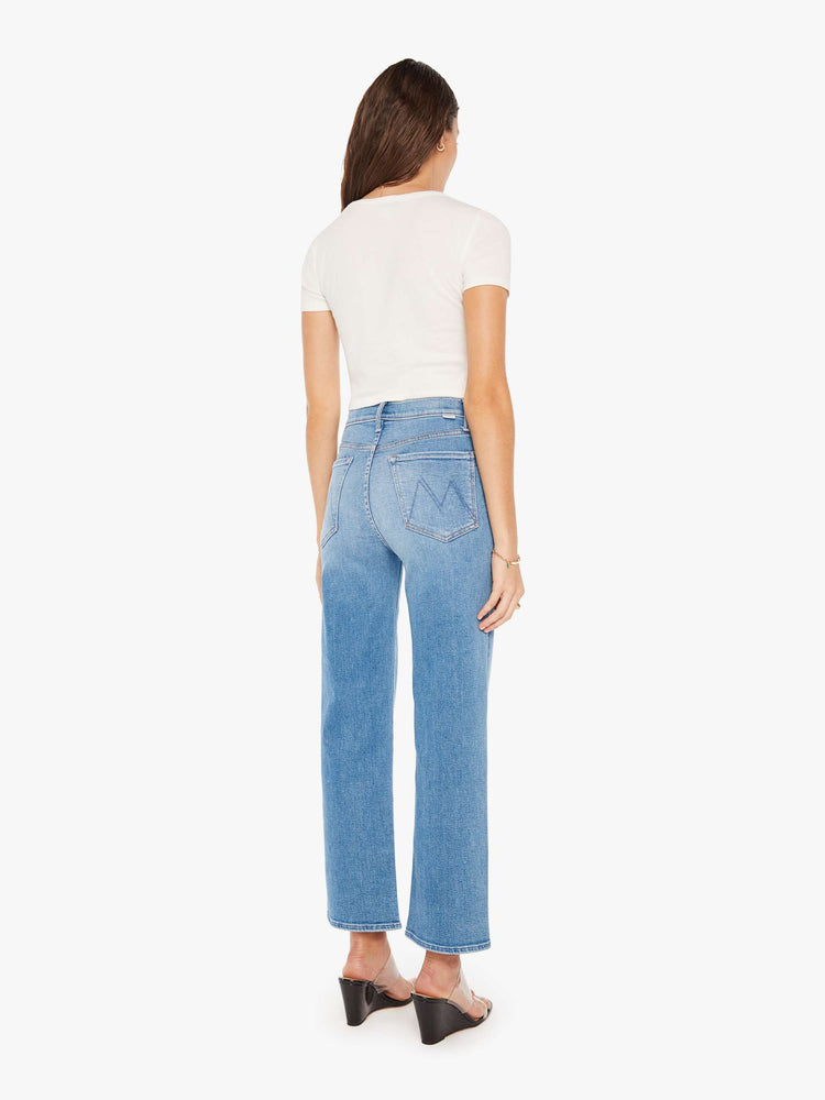 Back view of a woman high-waisted jean with a wide straight leg, zip fly and clean 28.25-inch inseam in a mid blue wash.