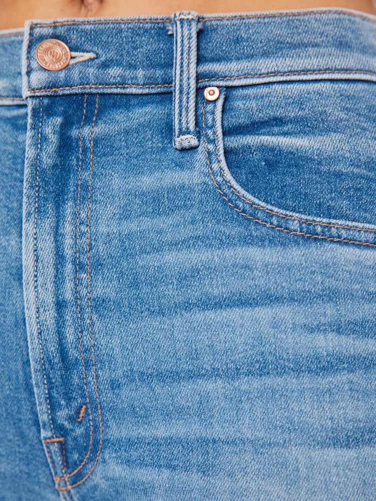 Swatch view of a woman high-waisted jean with a wide straight leg, zip fly and clean 28.25-inch inseam in a mid blue wash.