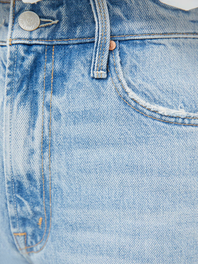 Swatch view of a woman in a light blue high-rise jeans with a wide straight leg, zip fly and 28.25-inch inseam with a clean hem.