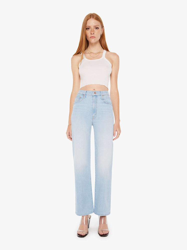 Front view of a womens light blue wash jean featuring a high rise and a wide straight leg with a clean flood length hem.