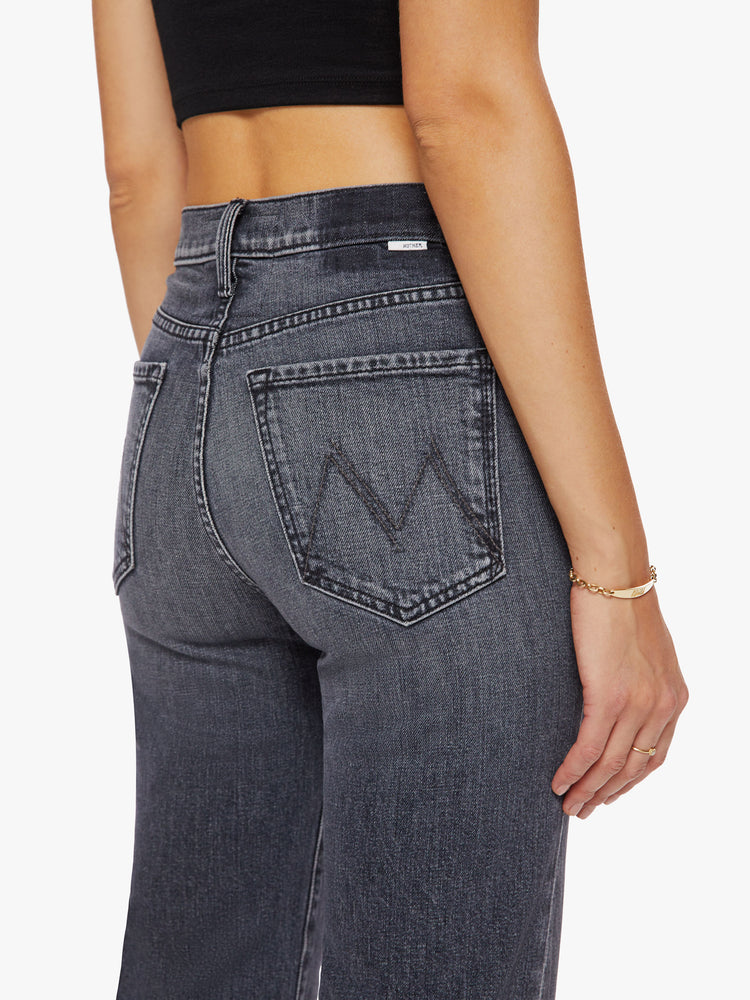 Close up back view of a woman high-waisted jeans with a wide straight leg, zip fly and clean 28 1/4-inch inseam in a dark grey hue.
