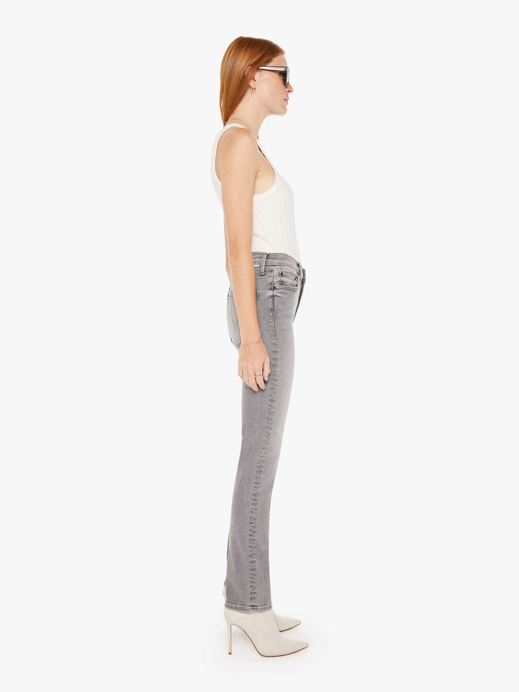 Side view of a womens grey wash jean featuring a mid rise and a straight leg with clean hem.