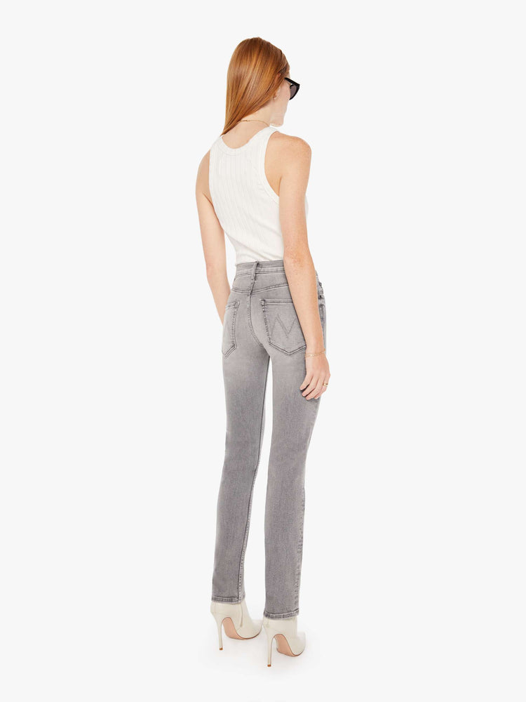Back view of a womens grey wash jean featuring a mid rise and a straight leg with clean hem.