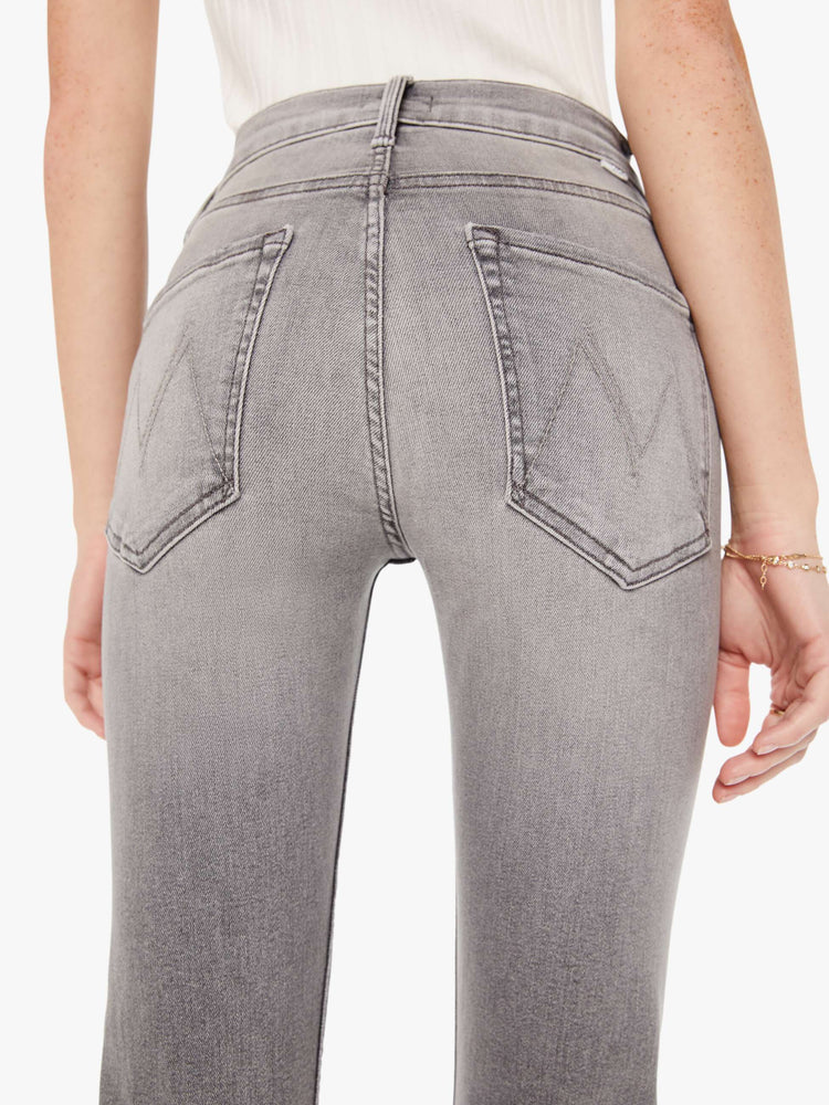 Back close up view of a womens grey wash jean featuring a mid rise and a straight leg.