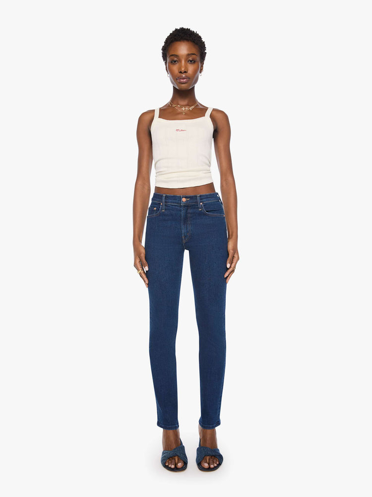 Front view of a woman in a dark blue mid-rise straight leg with a zip fly, 31-inch inseam and a clean hem.