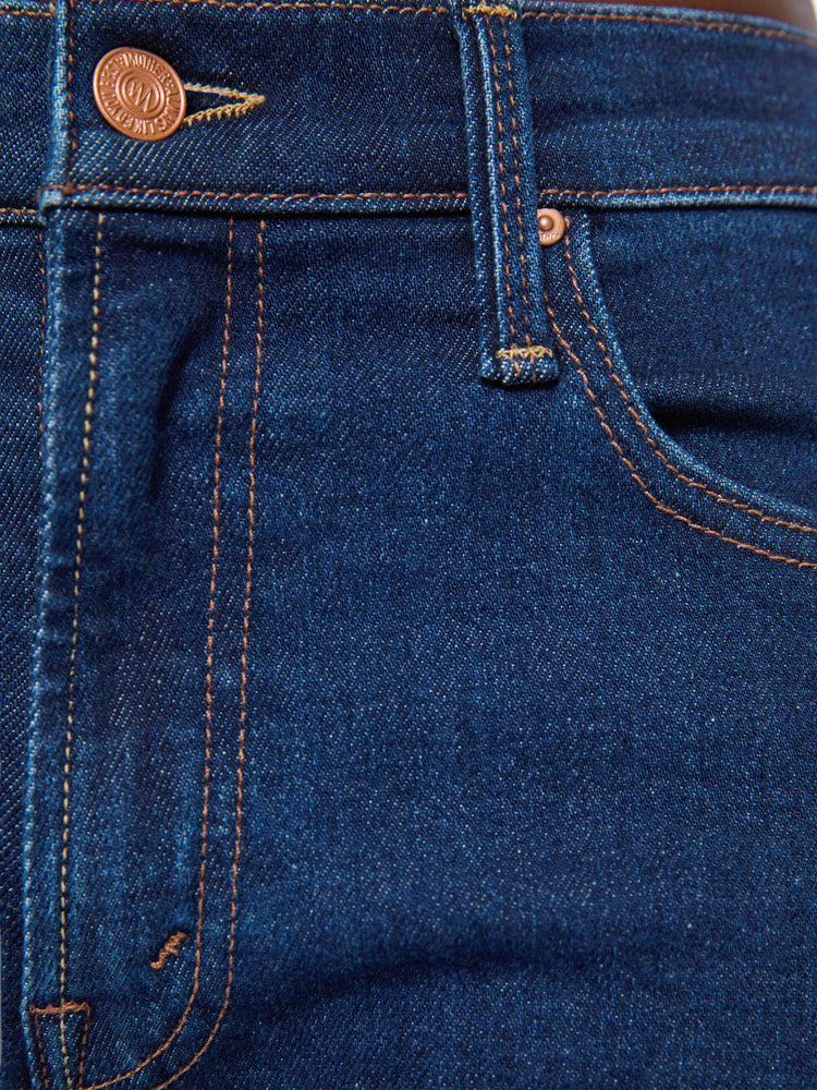 Swatch view of a woman in a dark blue mid-rise straight leg with a zip fly, 31-inch inseam and a clean hem.