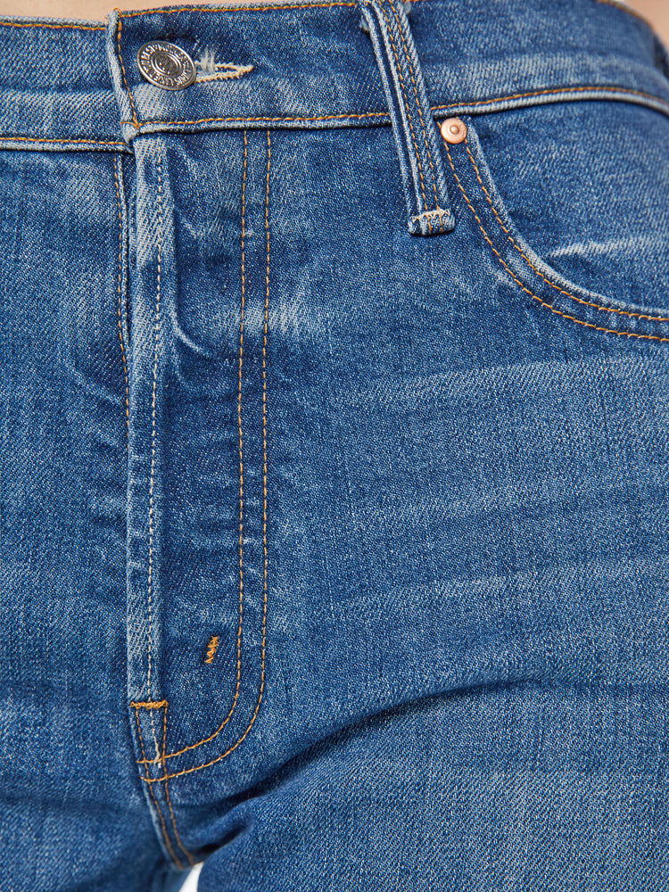 Swatch view of a woman classic blue jeans with a high rise, button fly, straight leg and a 31-inch inseam with a clean hem.