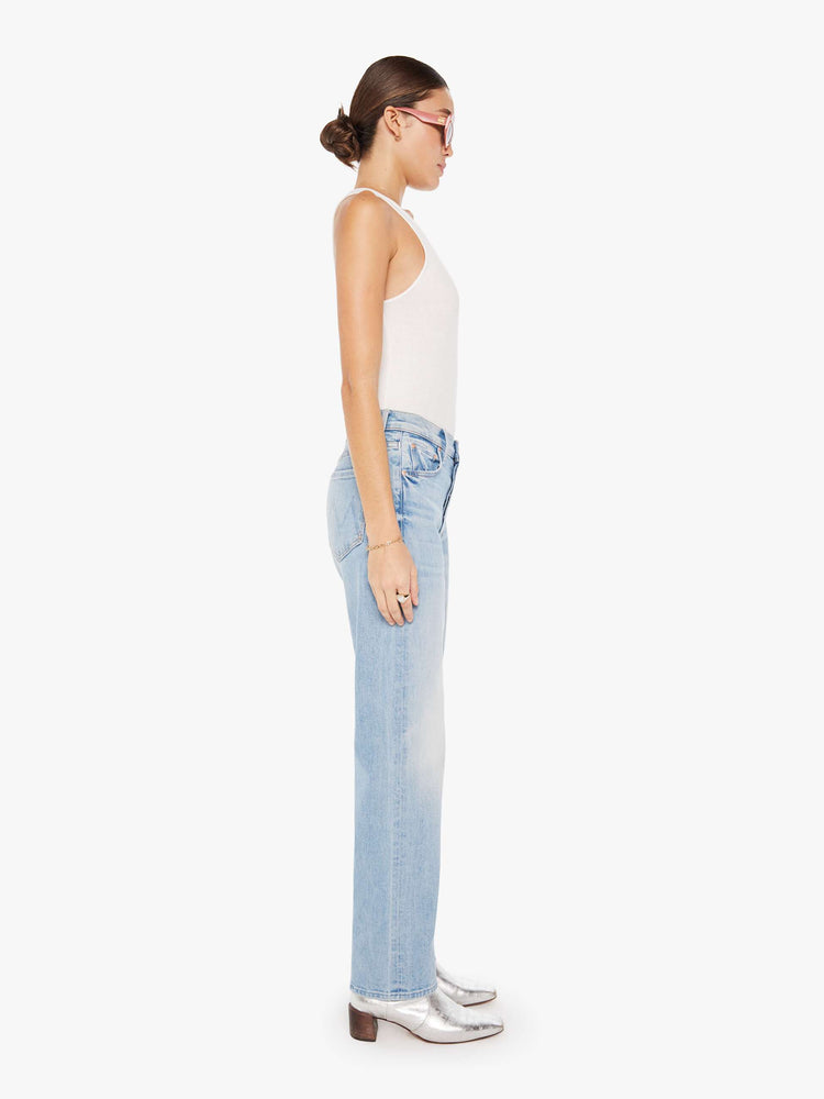 Side view of a womens light blue wash denim jean featuring a high rise, straight leg, and a full length clean hem.