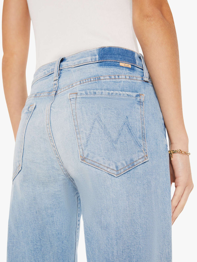 Back close up view of a light blue wash jean featuring a high rise.