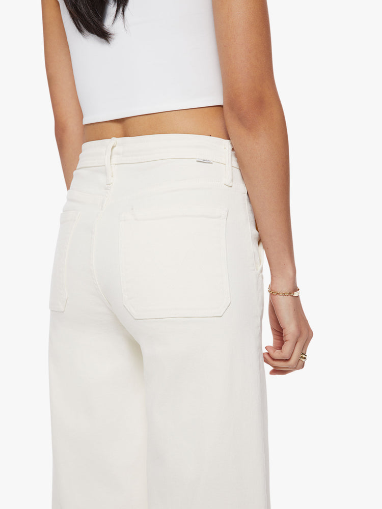 Back close up view of a woman wide-leg pant with a high rise, drawstring waistband and a 32-inch inseam with a clean hem in an off-white hue.