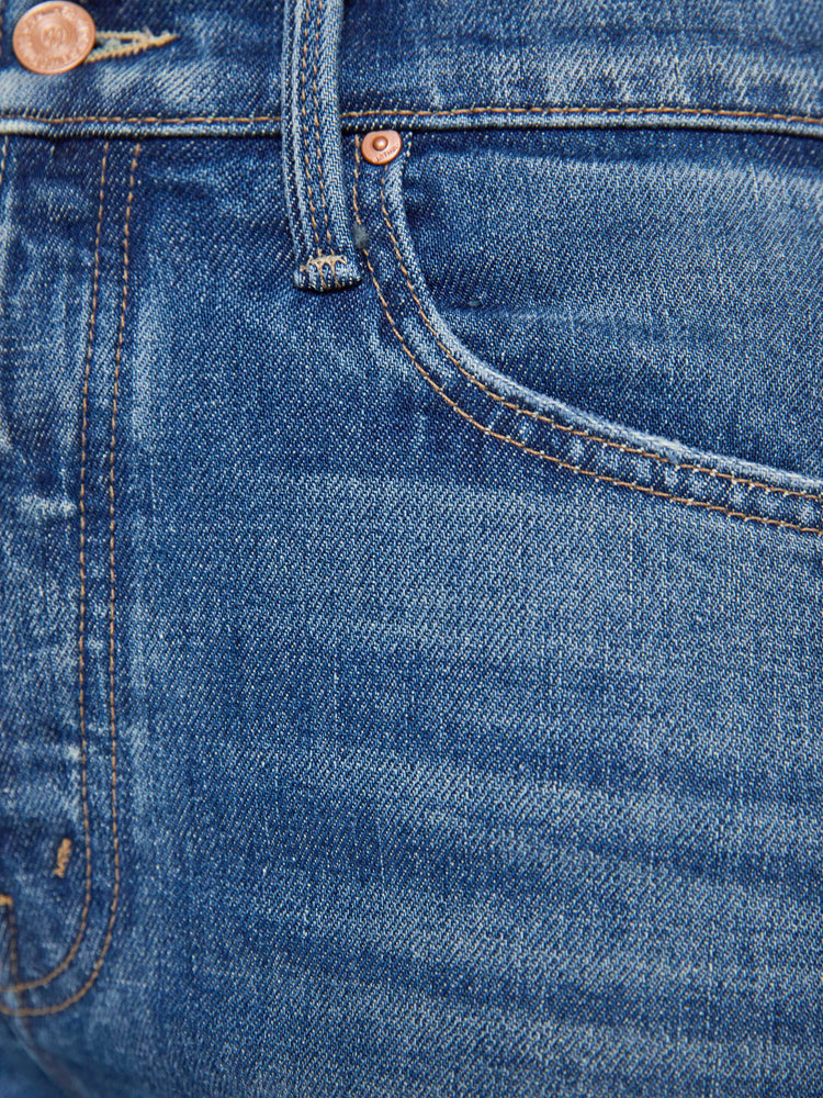 Swatch view of a woman in med blue high-waisted straight-leg jeans with a button fly, 29-inch inseam and a clean hem.