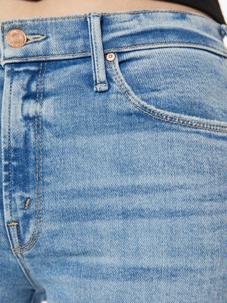Swatch view of a woman high-rise jeans with a wide leg and 31-inch inseam with a clean hem in a light blue wash.