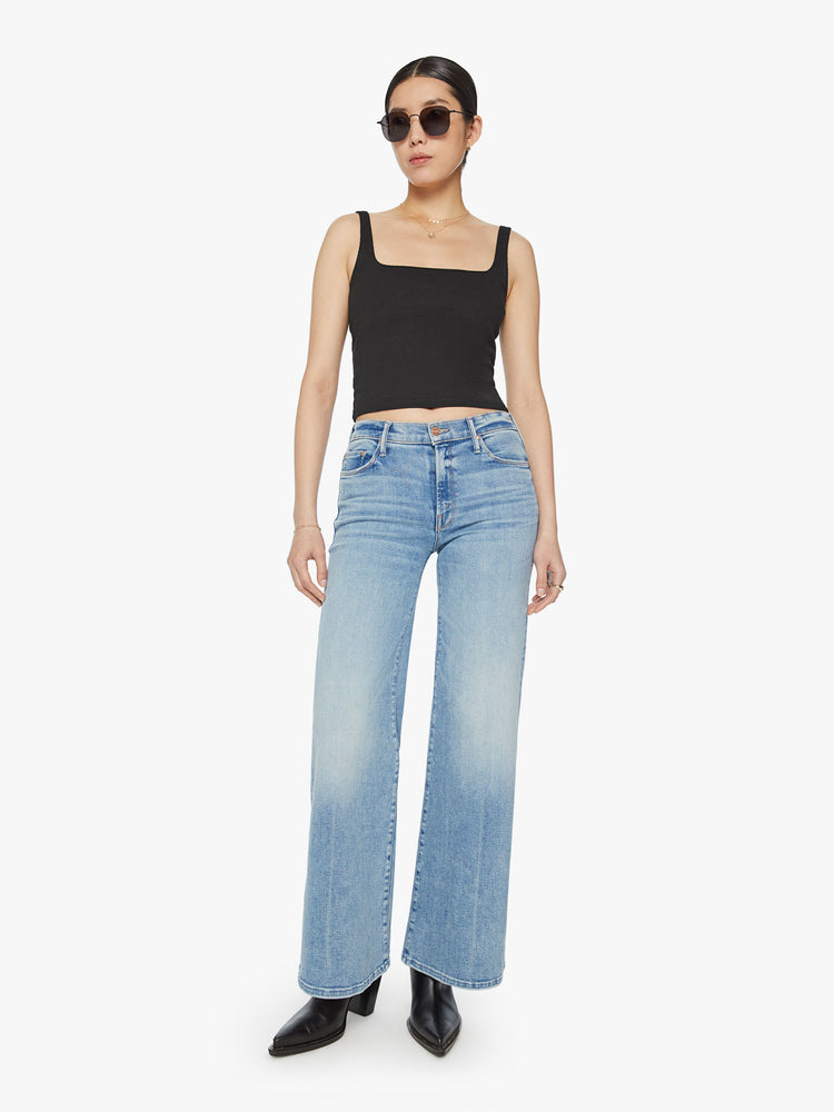Front view of a woman high-rise jeans with a wide leg and 31-inch inseam with a clean hem in a light blue wash.