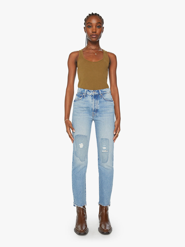Front view of a woman slim straight-leg jean with a button fly, low-set back pockets, a high waist and a 29-inch inseam with a chewed hem in a light blue wash.
