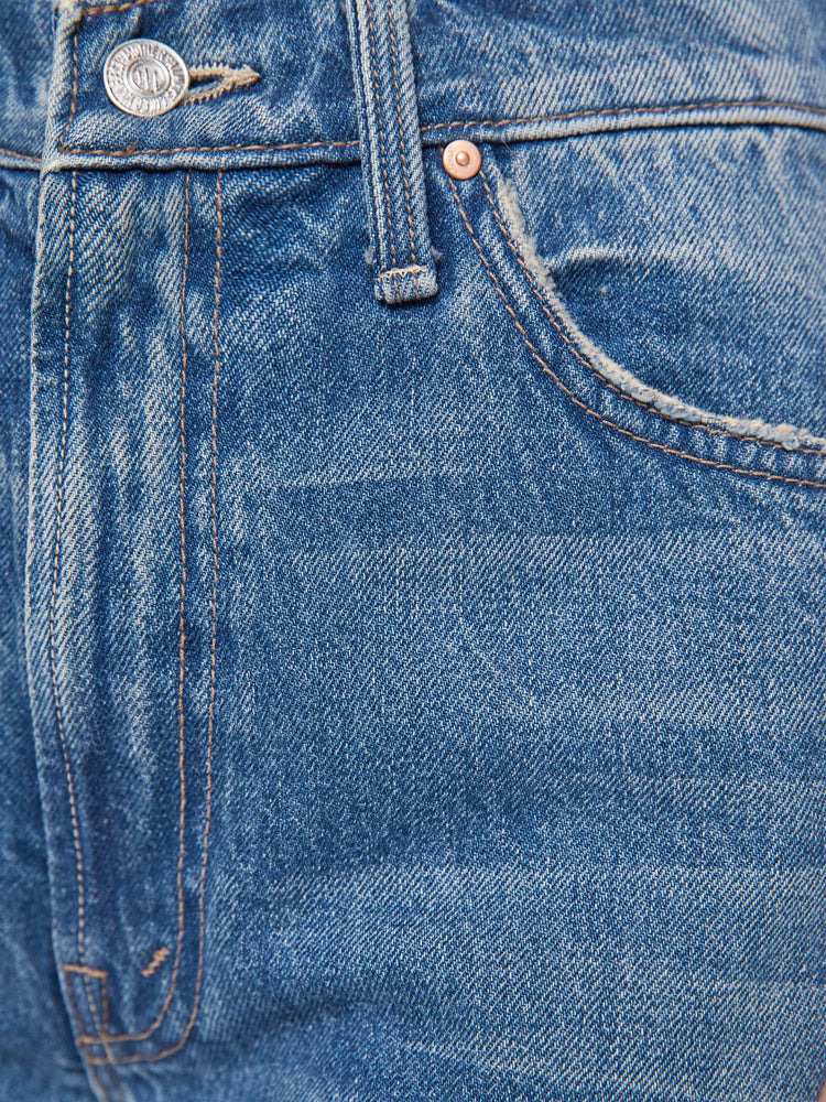 Swatch view of a woman in a med blue wide-leg jeans feature a slightly dropped crotch, zip fly, low-set back pockets and a 32-inch inseam.