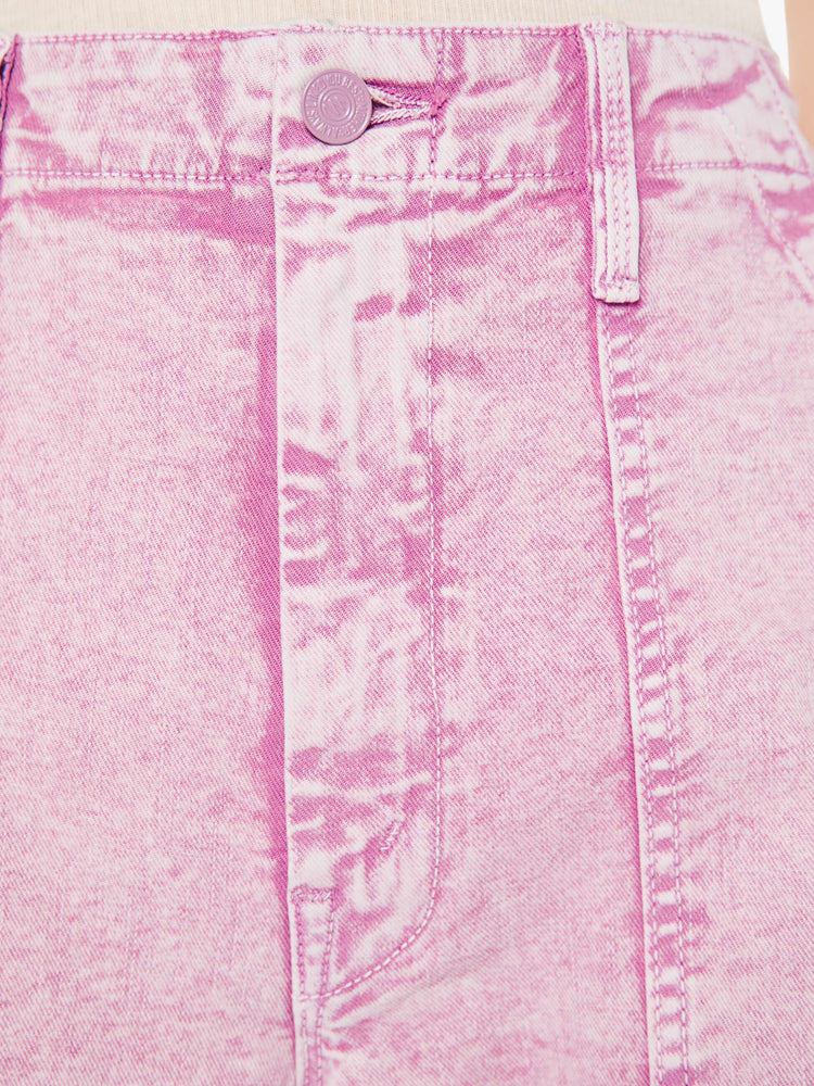 A close up swatch detail view of a light purple, acid wash pant.