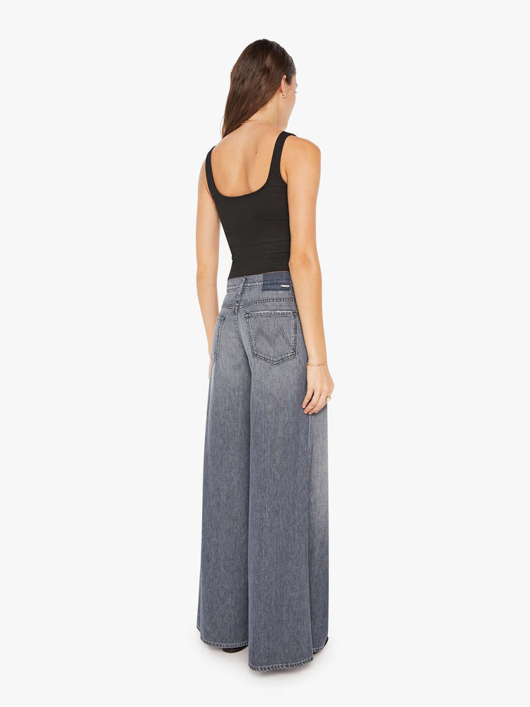 Back view of a womens grey wash jean featuring a high rise and a wide leg.