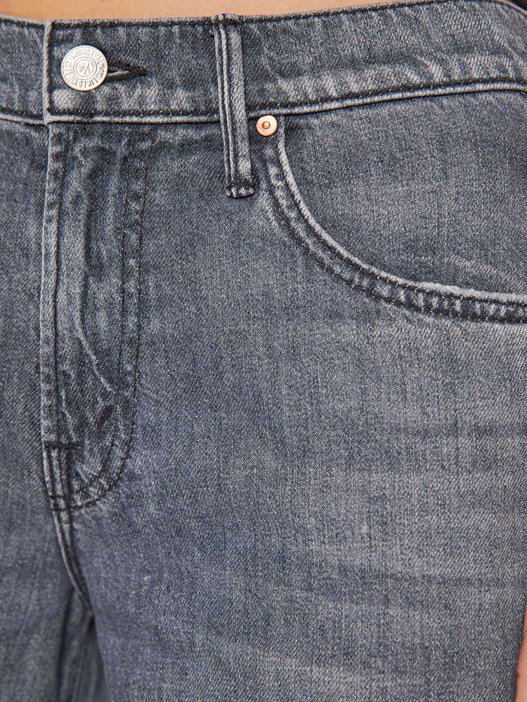 Close up swatch of a grey denim jean.