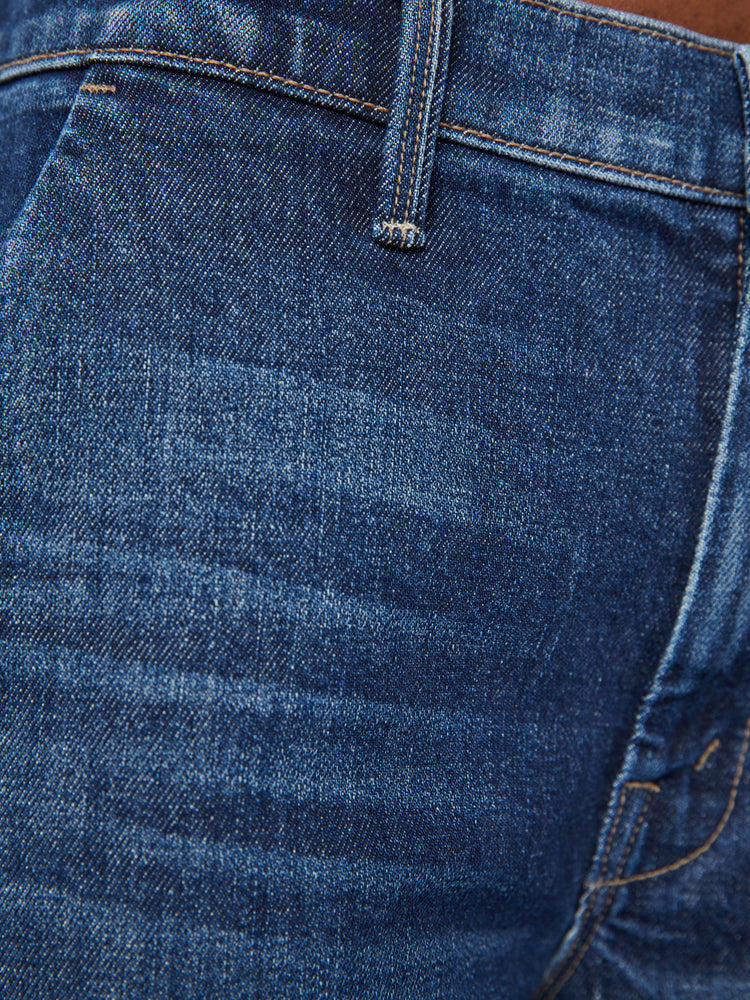 Swatch view of a woman high-waisted jeans with a loose wide leg, slit pockets and an ankle-length inseam in a dark blue wash.