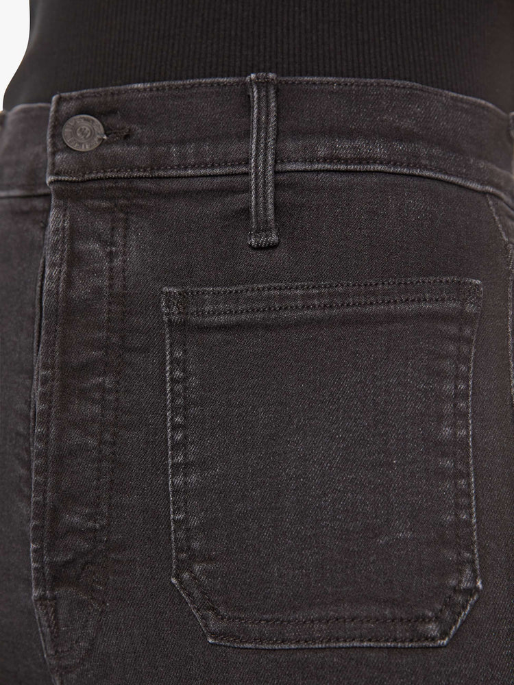 Swatch view of a woman black high-waisted jeans with a wide straight leg, patch pockets, zip fly and a long 32-inch inseam.
