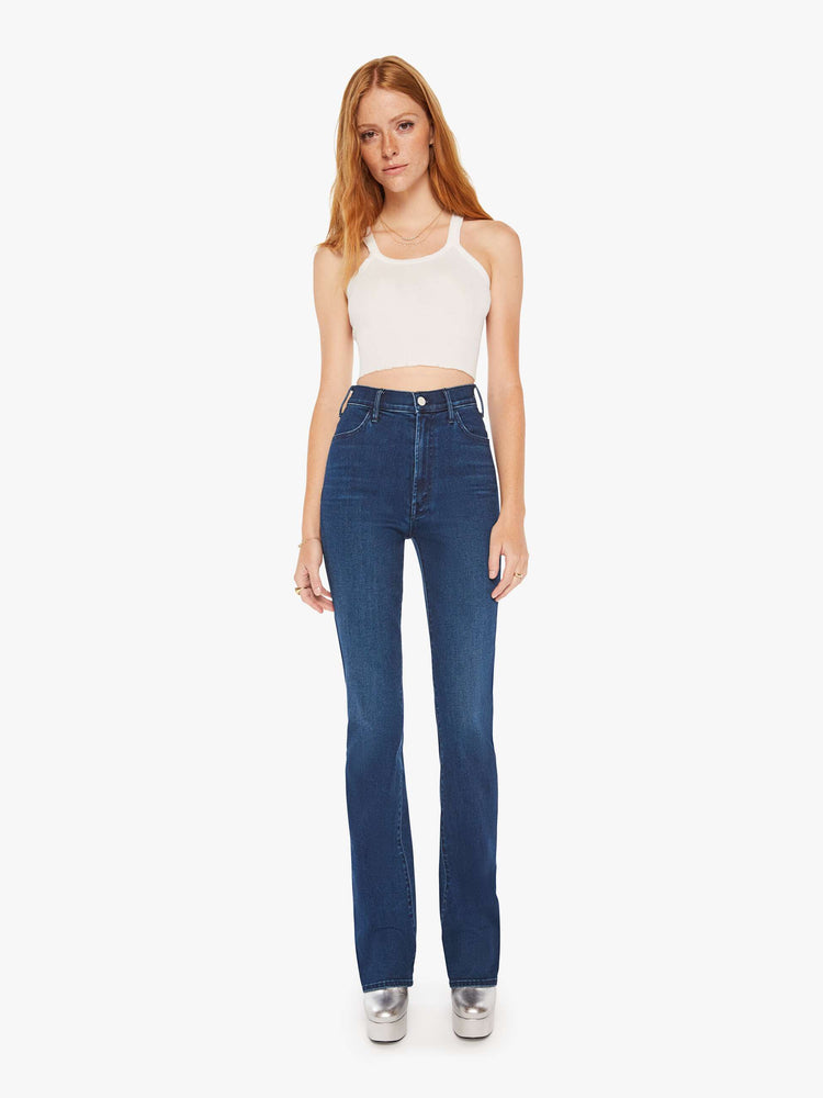 Front view of a woman dark blue wash high-waisted flare jeans with a long 34-inch inseam and a clean hem.