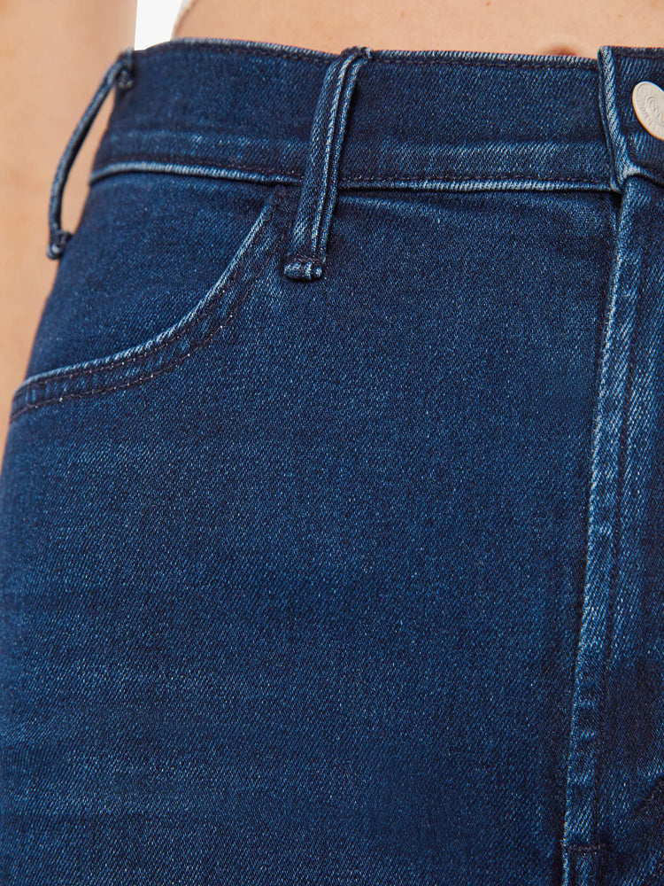 Swatch view of a woman dark blue wash high-waisted flare jeans with a long 34-inch inseam and a clean hem.