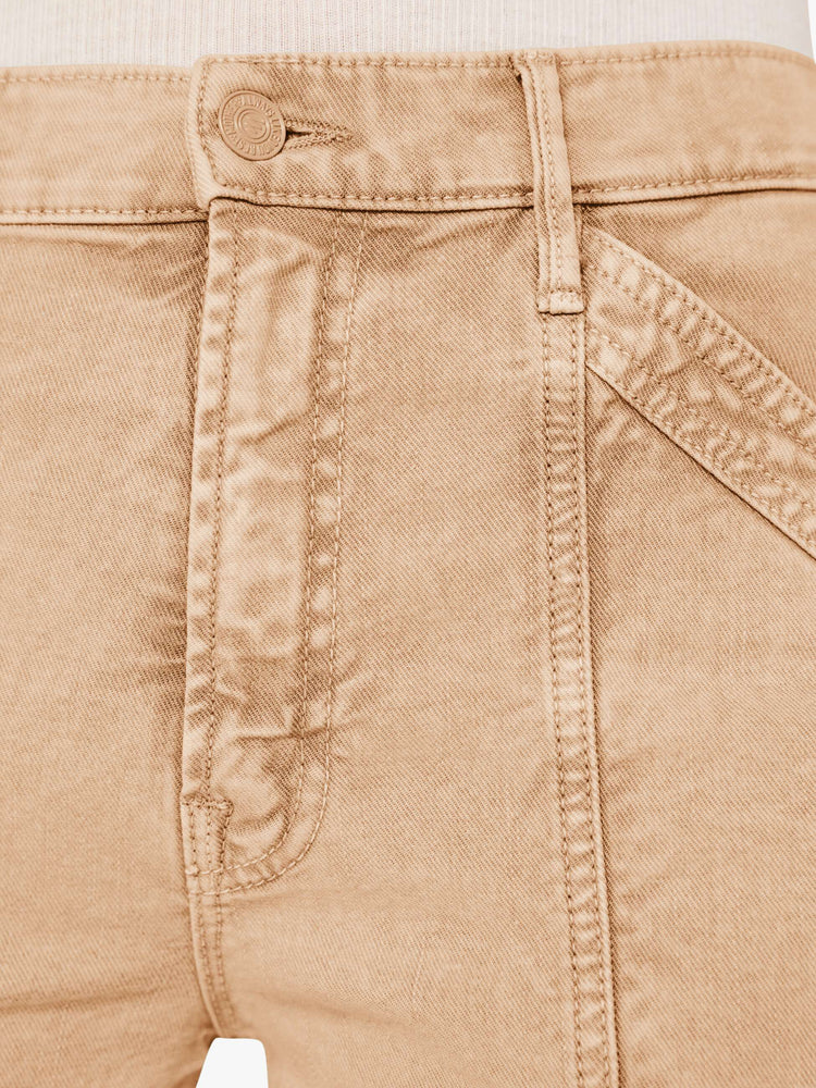 A close up swatch view of a light brown wash pant with darker brown hues around the tonal brown thread and matching brown hardware.