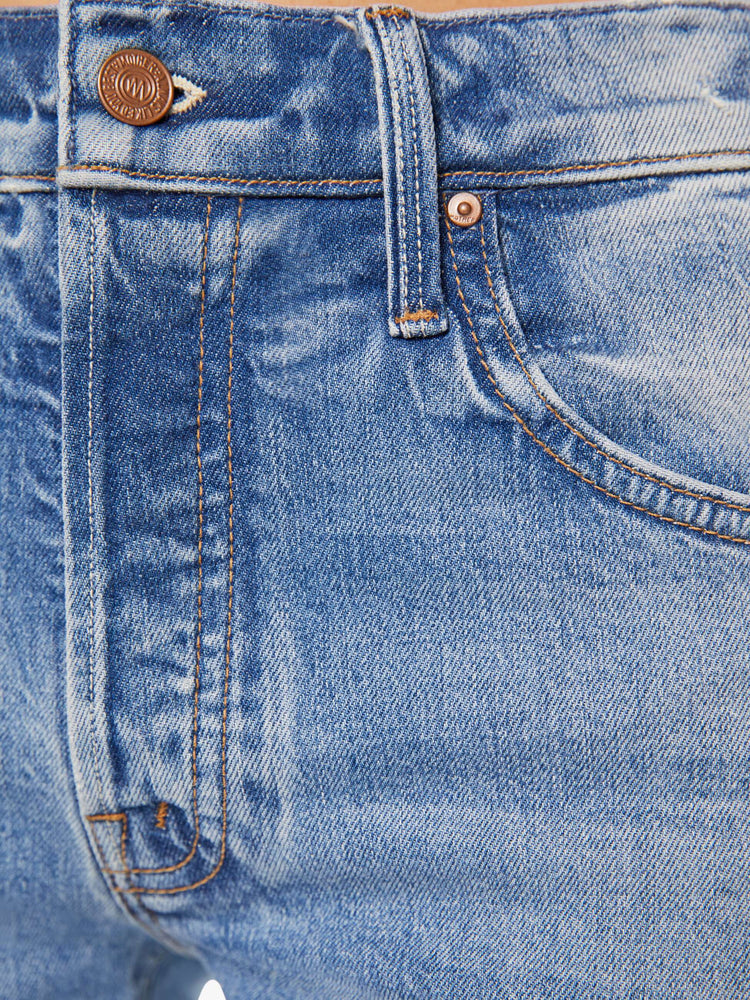 Swatch view of a woman in midblue straight-leg was adopted from our men’s line and features a mid rise, button fly, low-set back pockets, a 29-inch inseam and a clean hem.