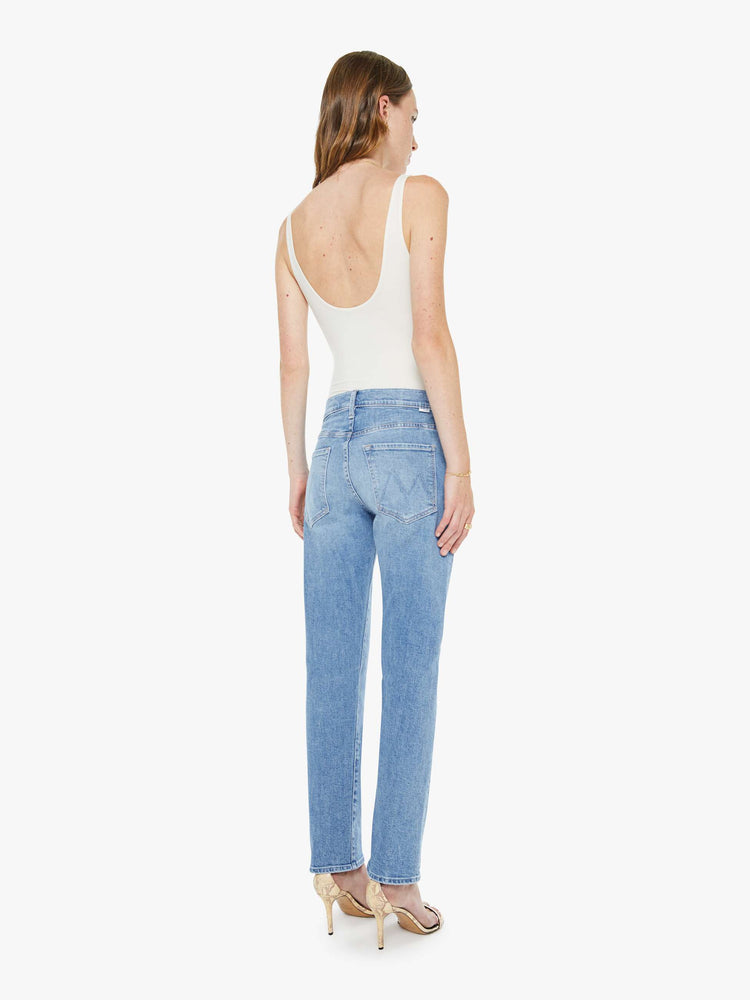 Back view of a woman in a light blue slim straight-leg was adopted from our men’s line and features a mid rise, button fly, low-set back pockets, a 29-inch inseam and a clean hem.