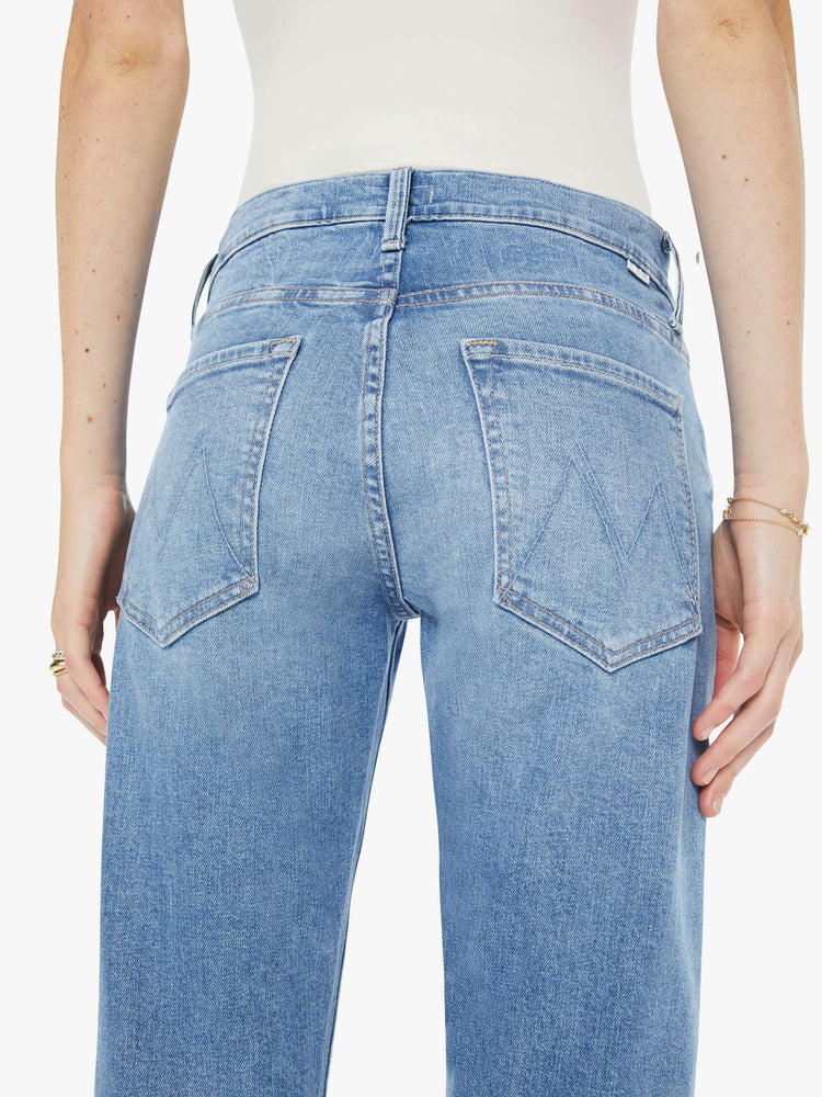 Close up view of a woman in a light blue slim straight-leg was adopted from our men’s line and features a mid rise, button fly, low-set back pockets, a 29-inch inseam and a clean hem.
