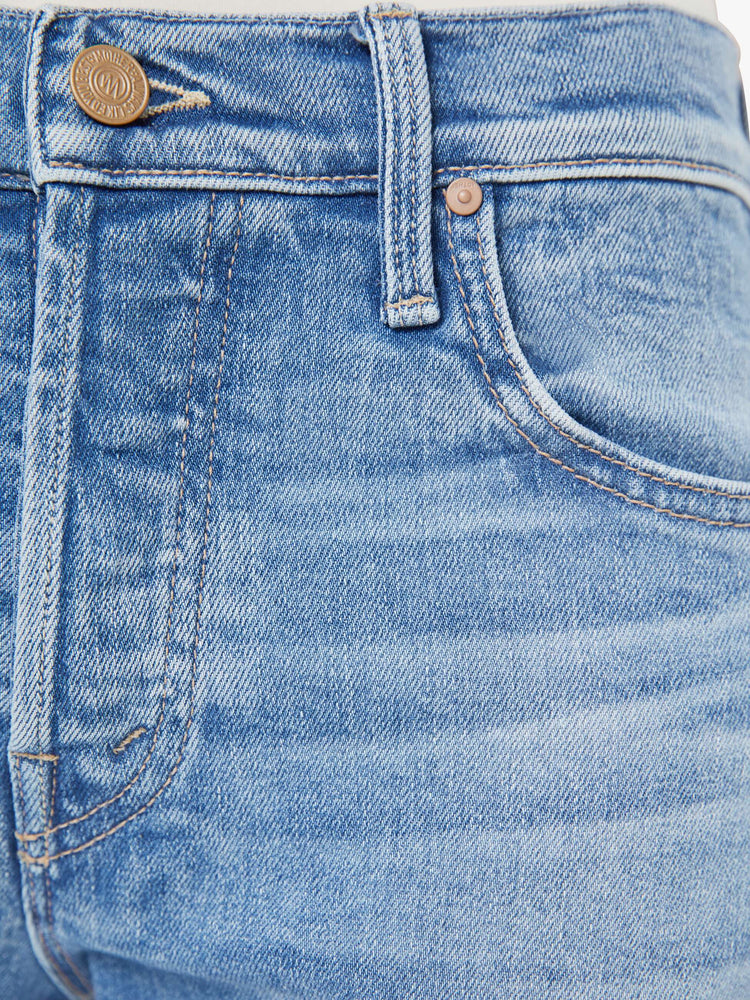 Swatch view of a woman in a light blue slim straight-leg was adopted from our men’s line and features a mid rise, button fly, low-set back pockets, a 29-inch inseam and a clean hem.