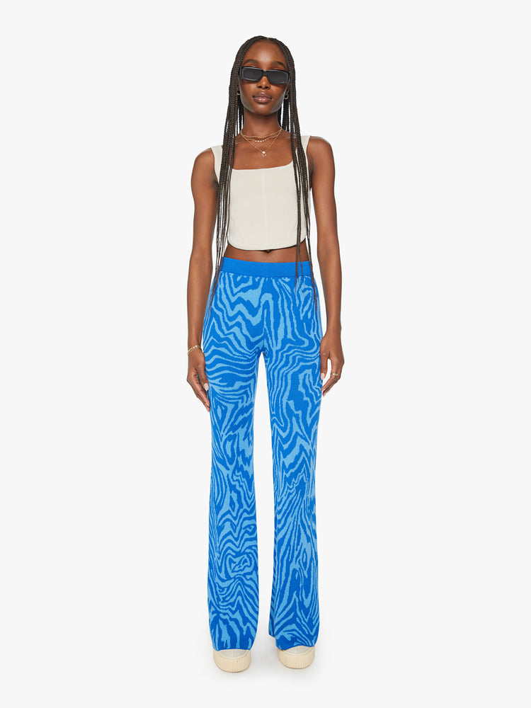 Front view of a woman high-waisted wide-leg flare with an elastic waist and a 31-inch inseam in blue zebra print.
