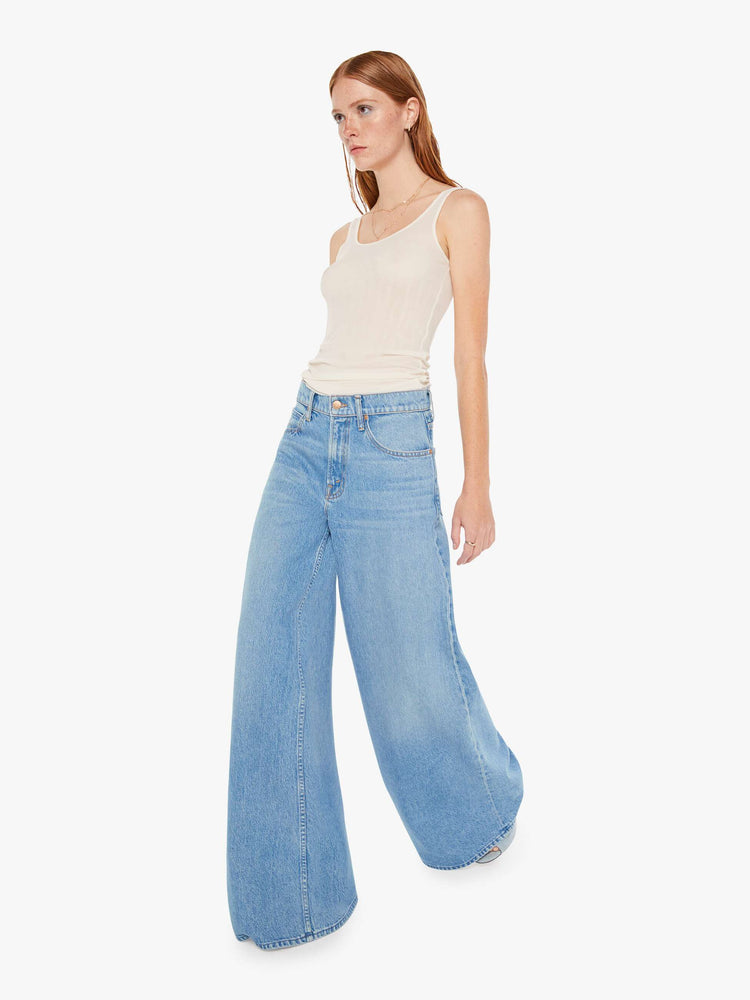 Front view of womens light blue jeans featuring a wide leg and relaxed slouch fit.