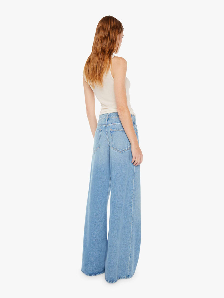 Back view of womens light blue jeans featuring a wide leg and relaxed slouch fit.