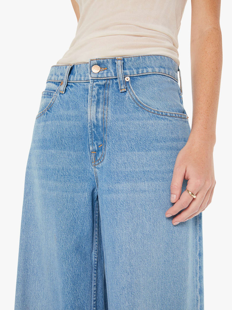 Front close up view of womens light blue jeans featuring a wide leg and relaxed slouch fit.