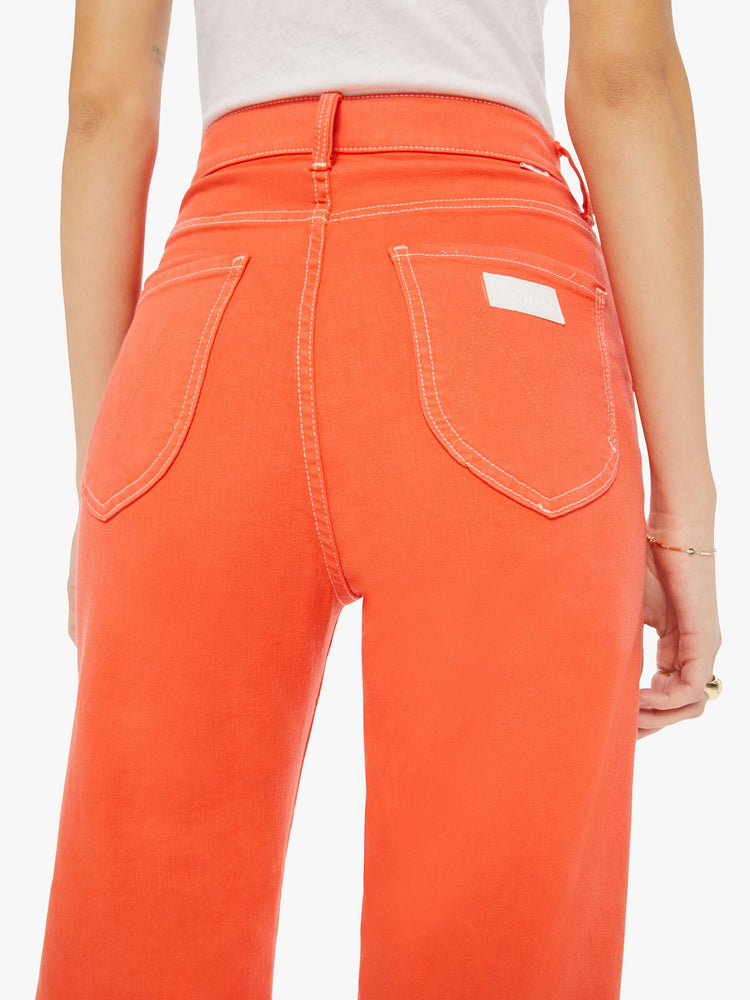 Back close up view of a womens bright coral jean featuring a super high rise and rolled cuff.