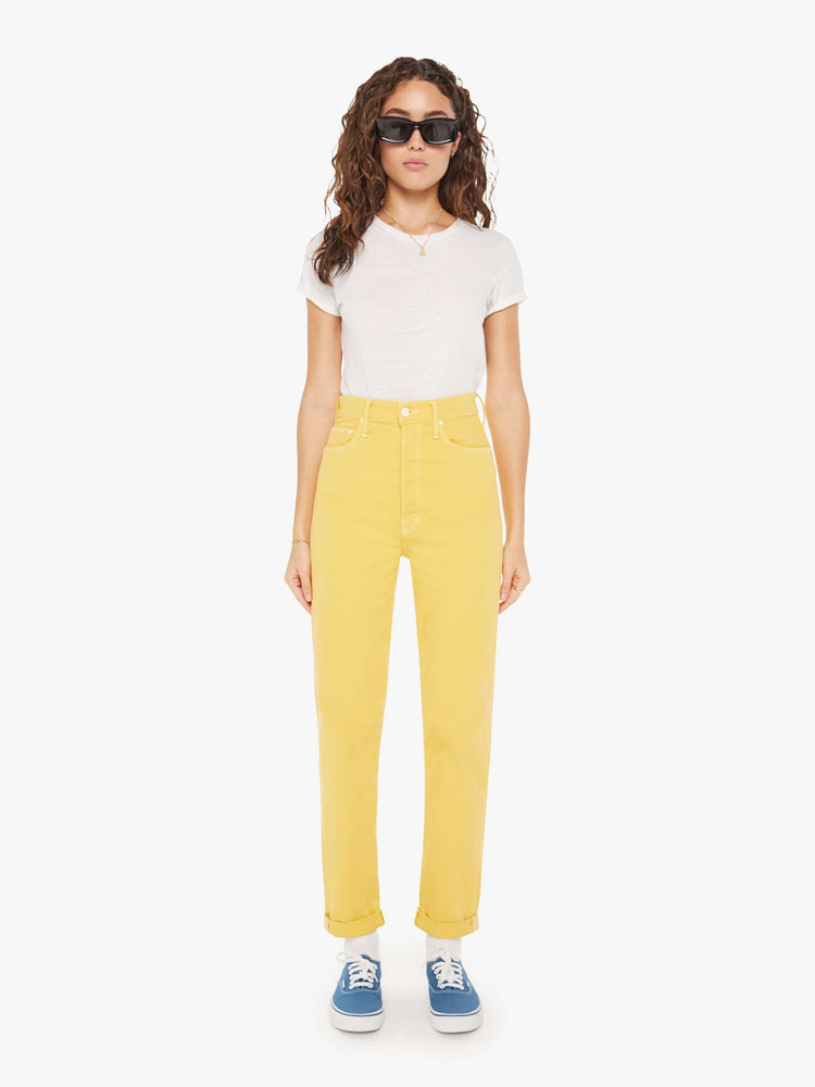 Front view of a womens yellow high rise jean featuring a cuffed hem.