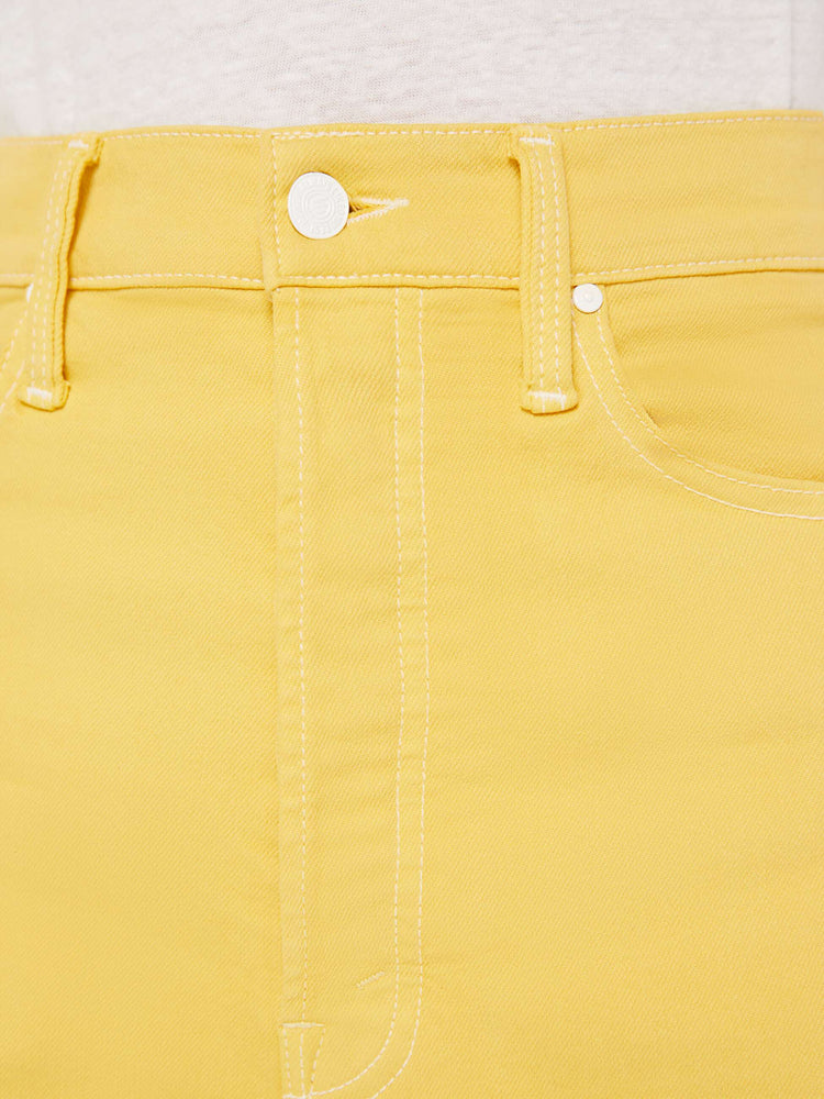 Front close up swatch view of a yellow jean with white contrast stitching.