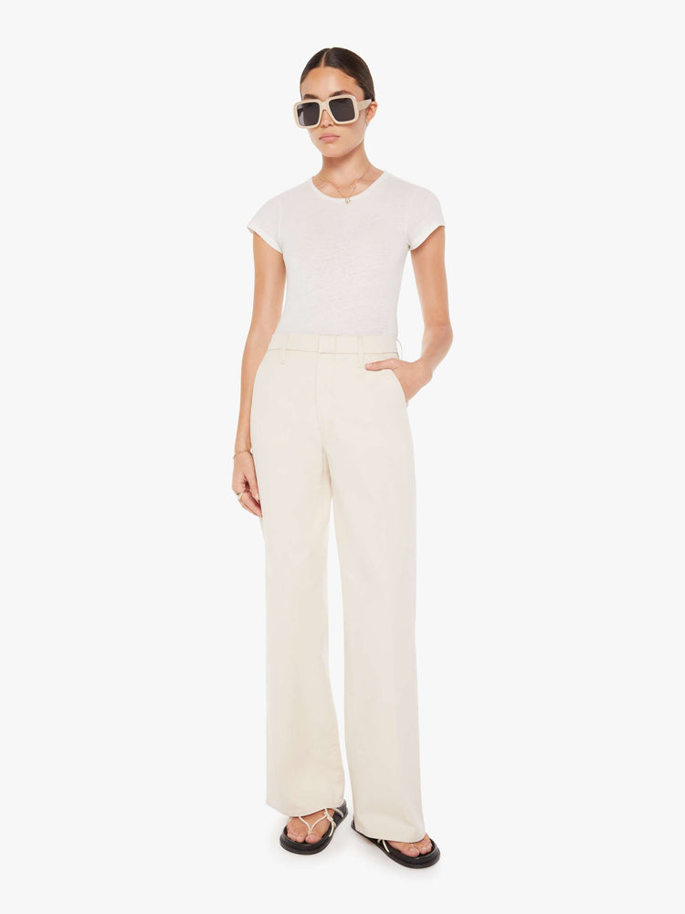 Front view of a womens ecru color pant featuring a relaxed mid rise, wide legs, and a clean full length hem.