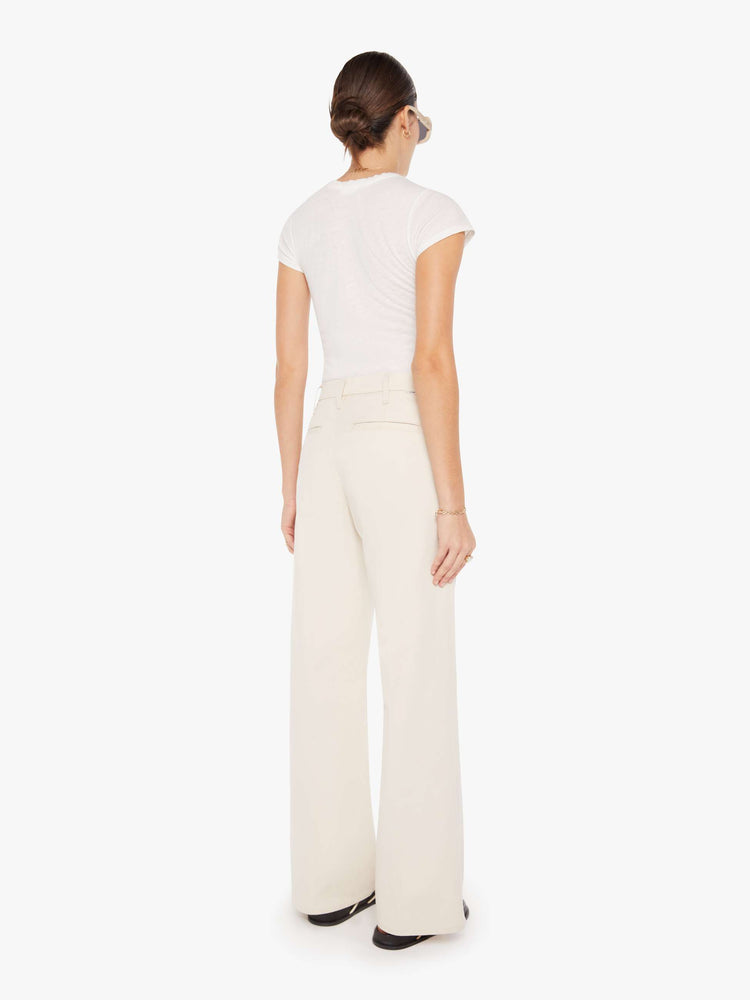 Back view of a womens ecru color pant featuring a relaxed mid rise, wide legs, and a clean full length hem.