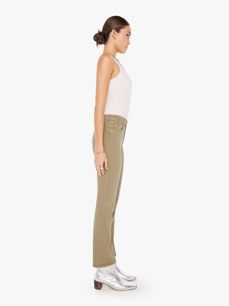 Side view of a womens greenish brown jean featuring a high rise and a bootcut leg with clean hem.