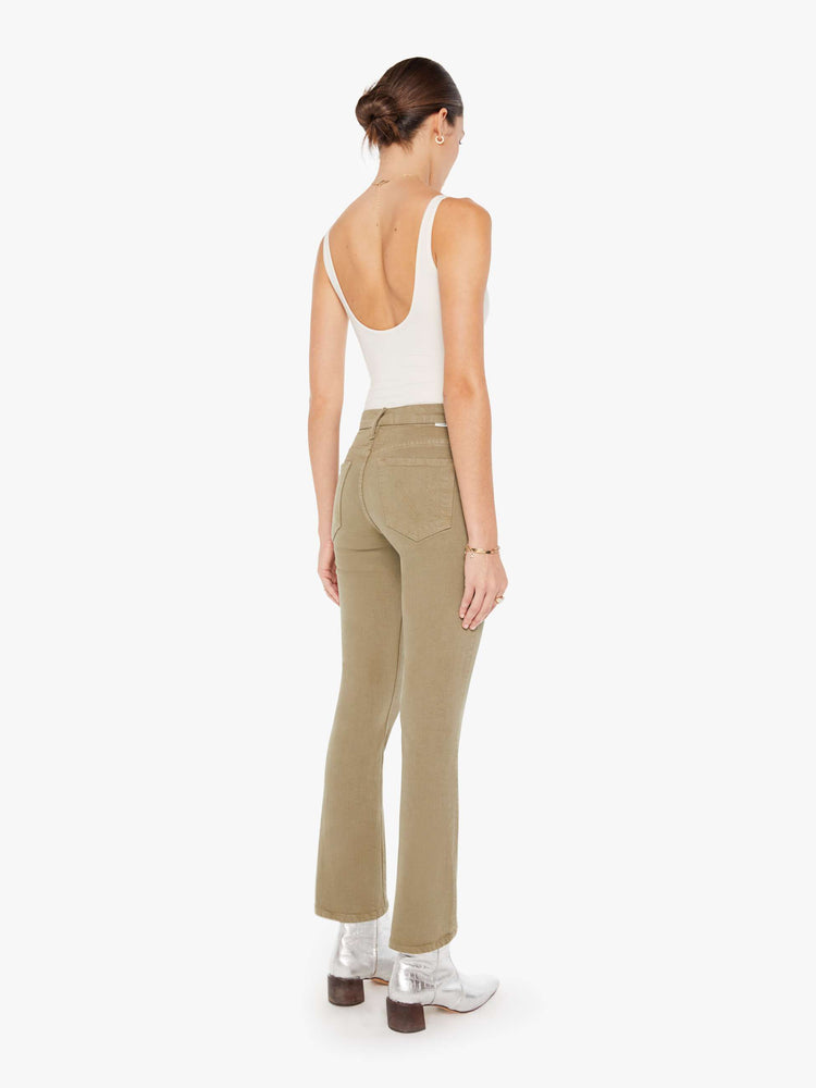 Back view of a womens greenish brown jean featuring a high rise and a bootcut leg with clean hem.