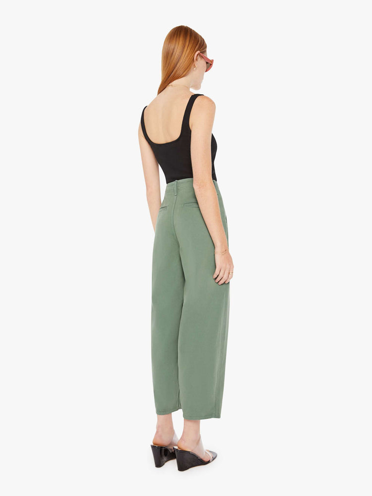 Back view of an army green pant featuring a super high rise with pleats, a wide leg, and a slightly tapered flood length hem.