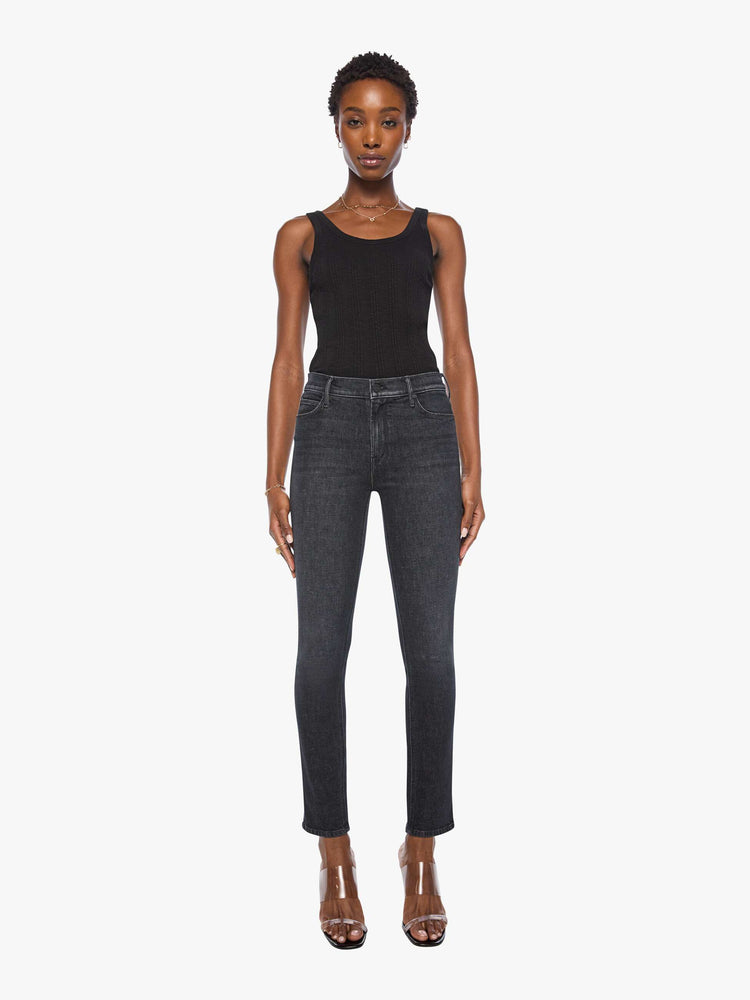 Front view of a woman in a black mid-rise straight leg jean with a zip fly, 31-inch inseam and a clean hem.