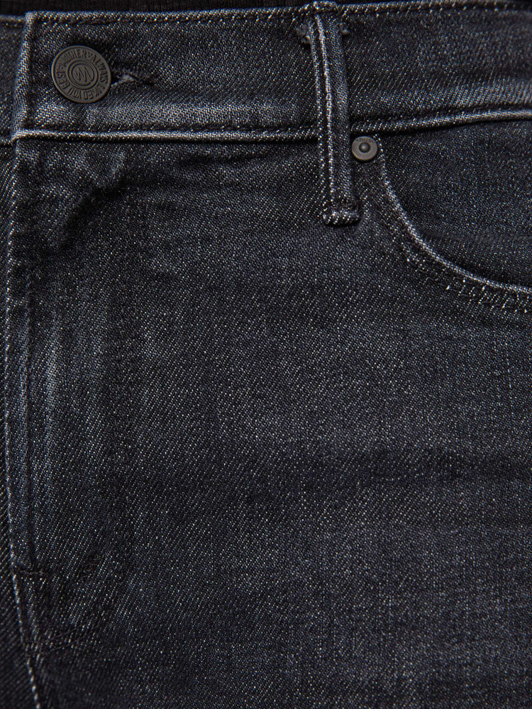 Swatch view of a woman in a black mid-rise straight leg jean with a zip fly, 31-inch inseam and a clean hem.