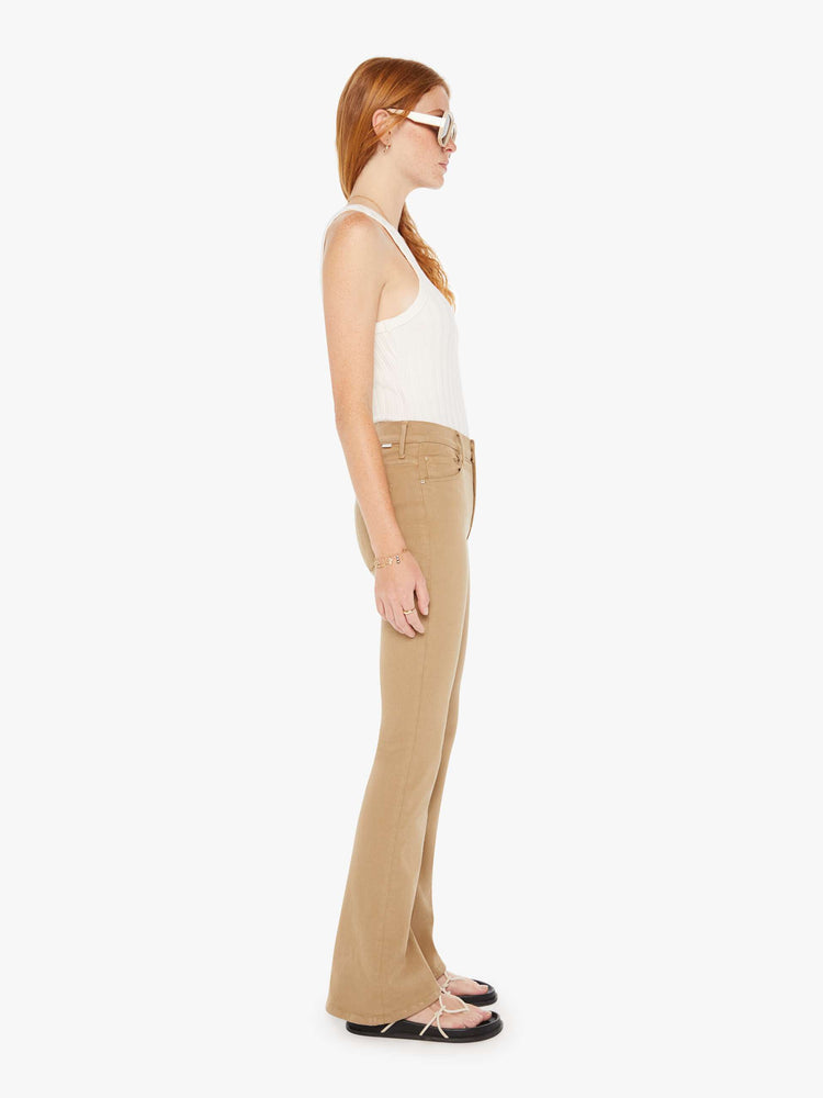 Side view of a womens brown pant featuring a mid rise and long flare leg,
