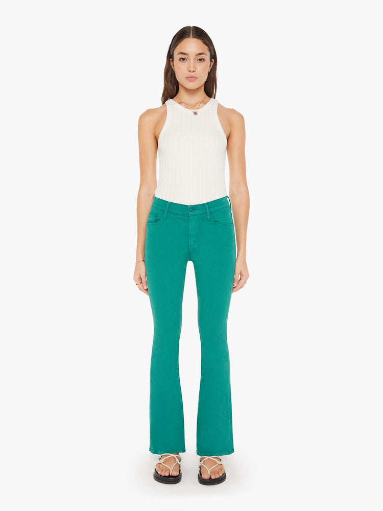 Front view of a womens teal pant featuring a mid rise and long flare leg.