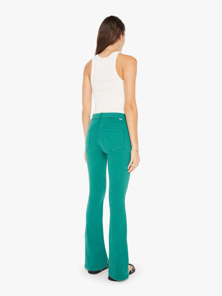 Back view of a womens teal pant featuring a mid rise and long flare leg.